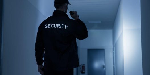 stockfresh_6690014_security-guard-with-flashlight-in-building-corridor_sizel_36269e