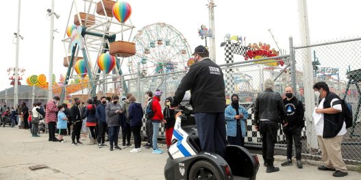 Guests line up on the first day of the Coney Island parks reopening, during the coronavirus disease (COVID-19) pandemic, in the Coney Island neighborhood of Brooklyn, New York, U.S., April 9, 2021.  REUTERS/Brendan McDermid